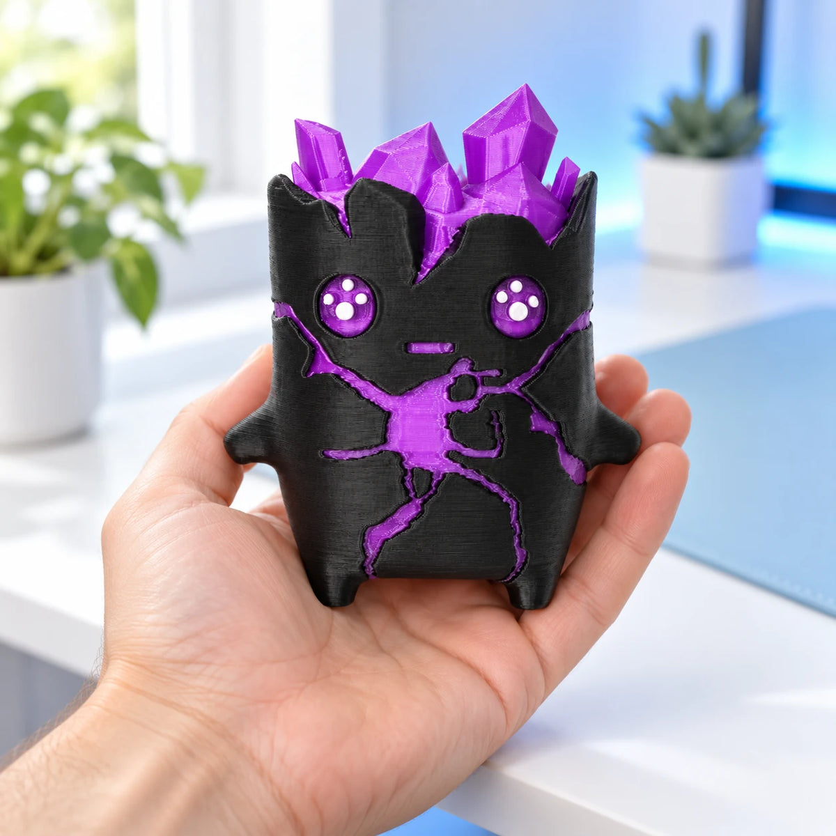 Crystal companion held in a hand, showing its compact size and 3D printed texture